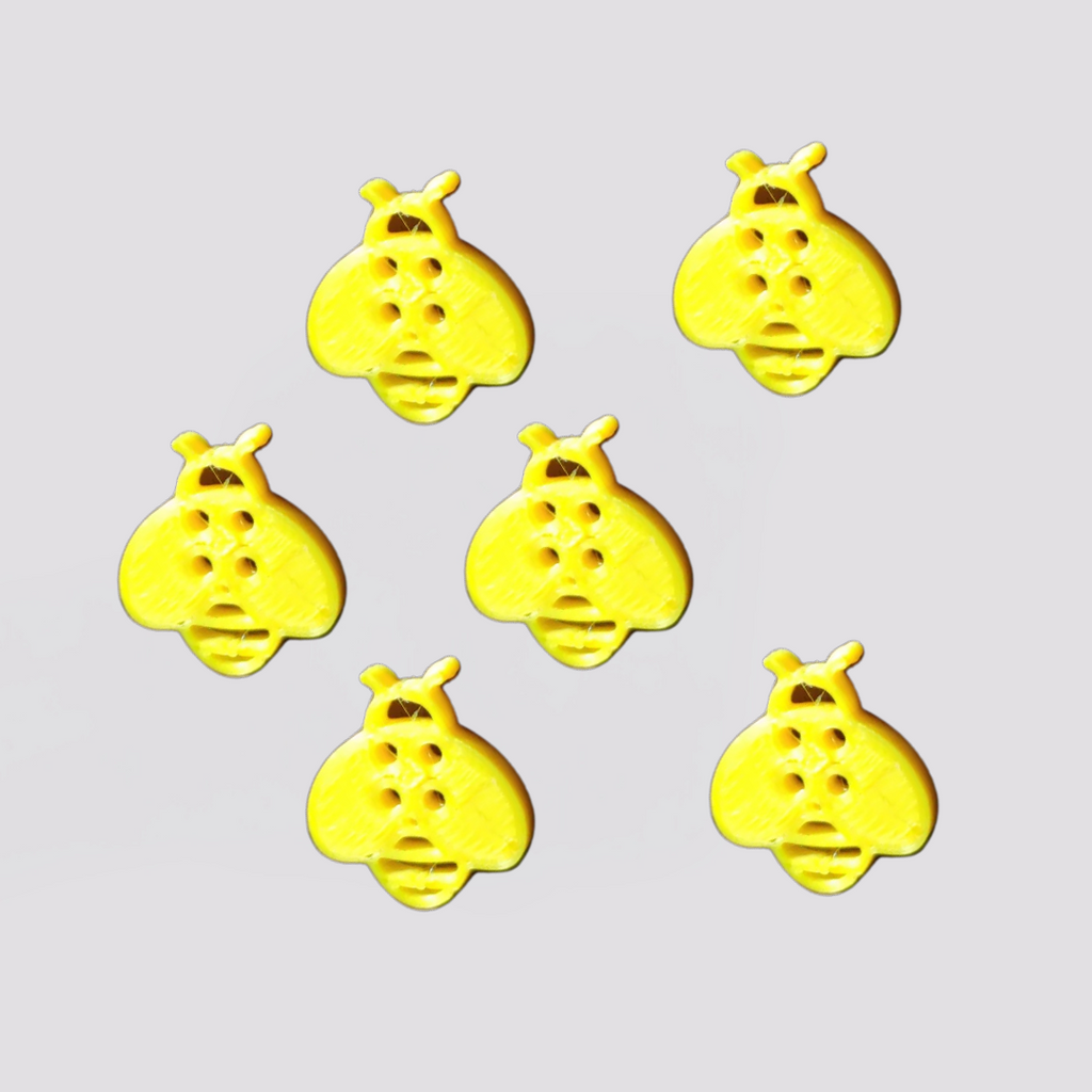 Set of six yellow children's bee buttons for clothing with four holes for sewing