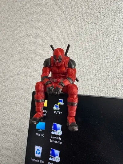 Sad Deadpool sitting on a ledge Figurine!