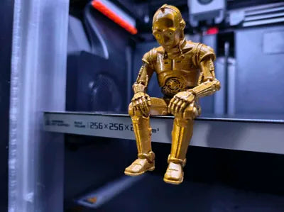 Sad C-3PO Star Wars Figurine sitting on a ledge!