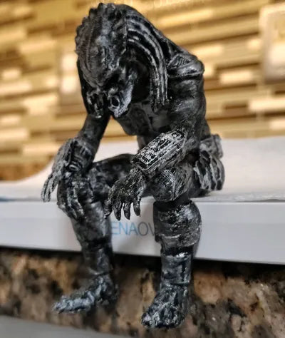 Sad Predator Figurine sitting on a ledge!