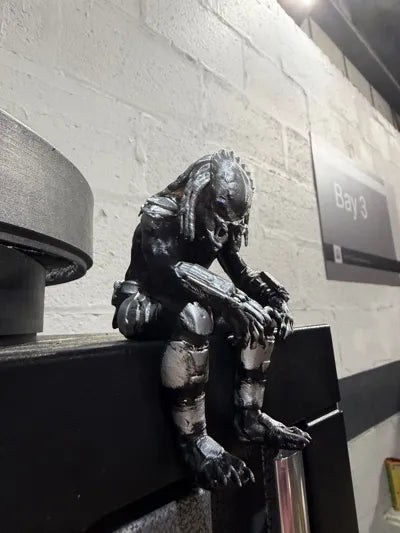 Sad Predator Figurine sitting on a ledge!