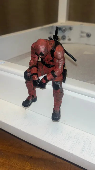 Sad Deadpool sitting on a ledge Figurine!