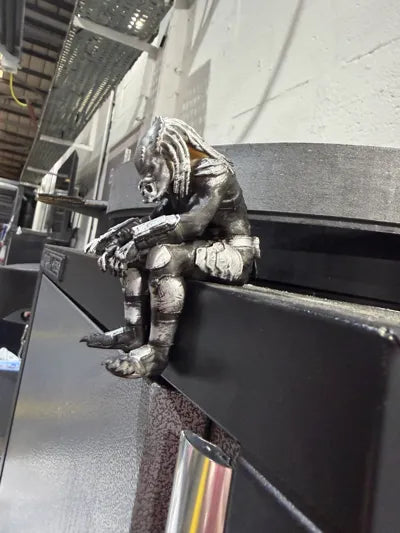Sad Predator Figurine sitting on a ledge!