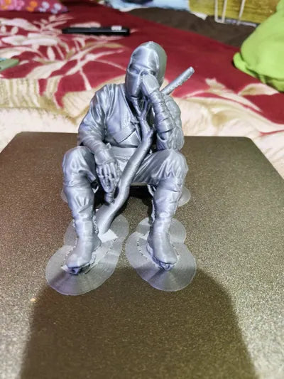 Sad Ninja sitting on a ledge Figurine!