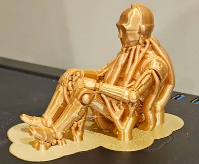 Sad C-3PO Star Wars Figurine sitting on a ledge!