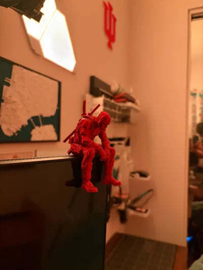 Sad Deadpool sitting on a ledge Figurine!