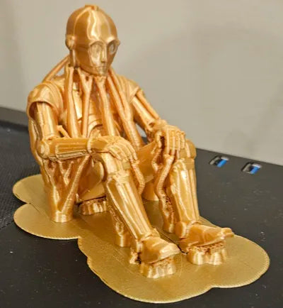 Sad C-3PO Star Wars Figurine sitting on a ledge!
