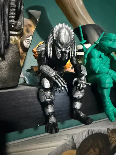 Sad Predator Figurine sitting on a ledge!