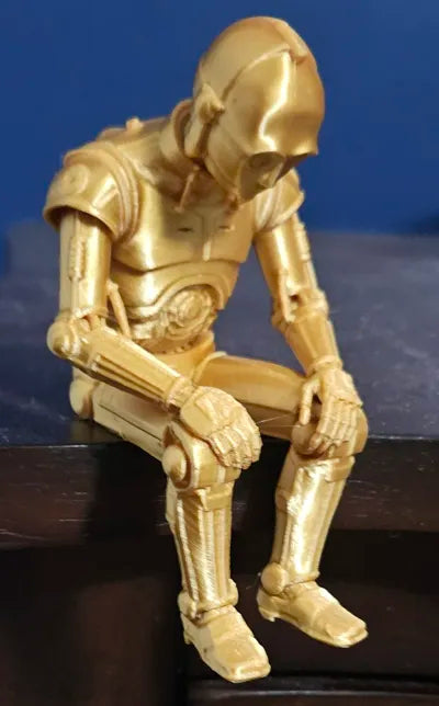 Sad C-3PO Star Wars Figurine sitting on a ledge!