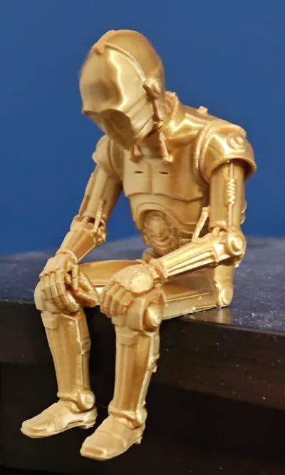 Sad C-3PO Star Wars Figurine sitting on a ledge!