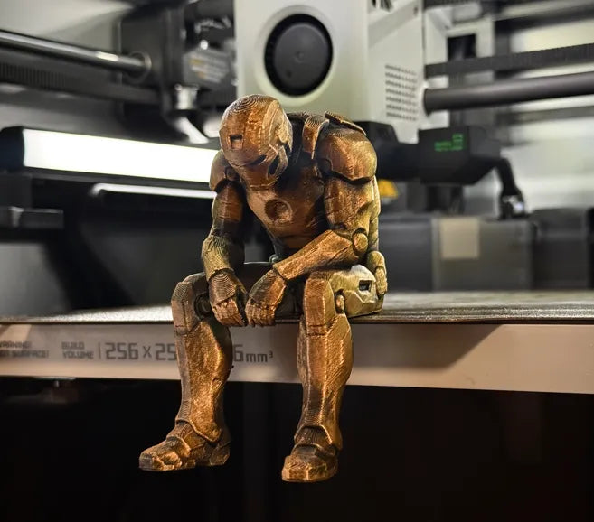 Sad Iron Man Figurine sitting on a ledge!