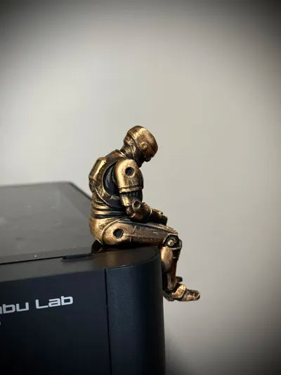 Sad RoboCop figurine sitting on a ledge!
