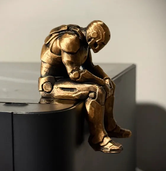 Sad Iron Man Figurine sitting on a ledge!