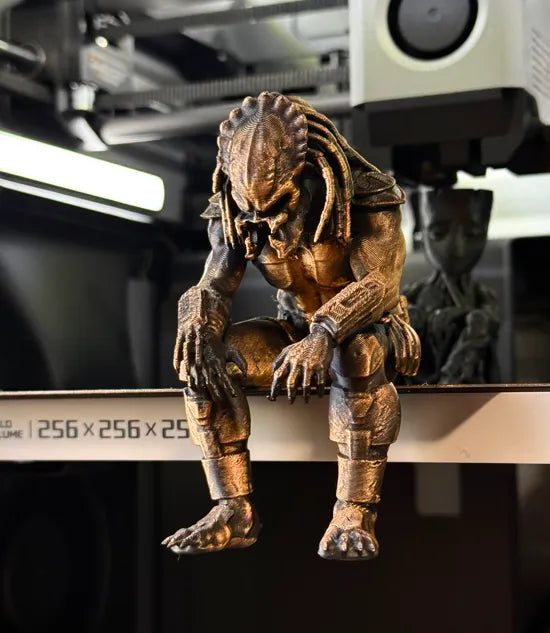 Sad Predator Figurine sitting on a ledge!