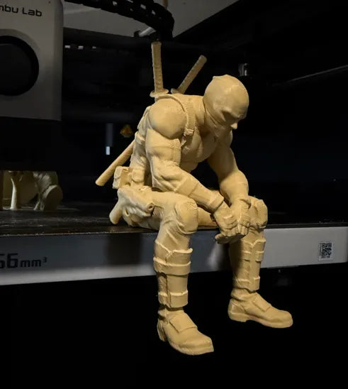 Sad Deadpool sitting on a ledge Figurine!
