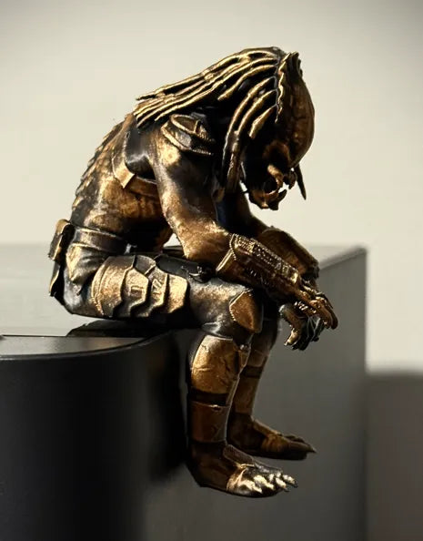 Sad Predator Figurine sitting on a ledge!