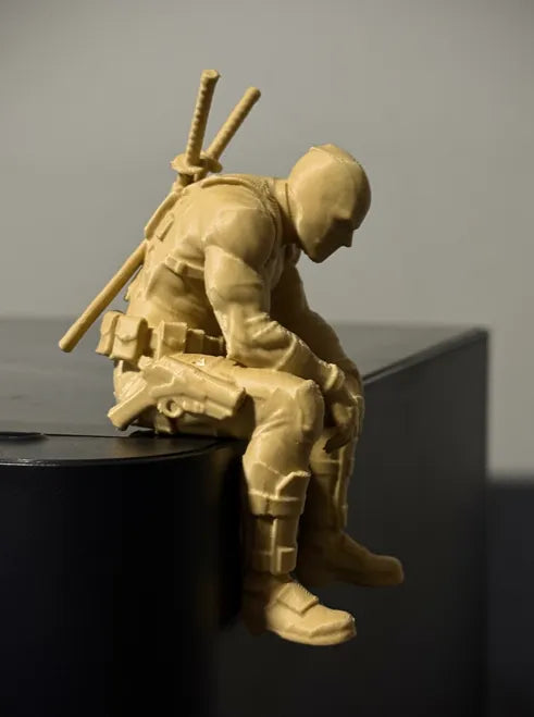 Sad Deadpool sitting on a ledge Figurine!