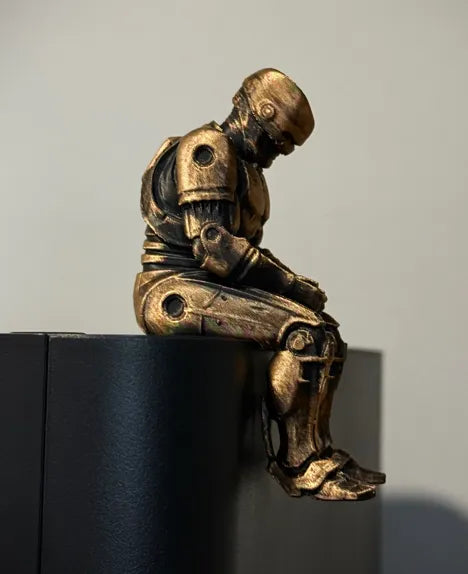 Sad RoboCop figurine sitting on a ledge!