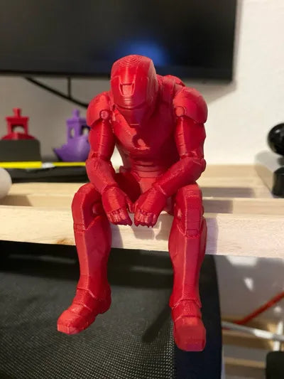 Sad Iron Man Figurine sitting on a ledge!