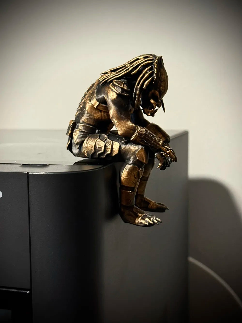 Sad Predator Figurine sitting on a ledge!