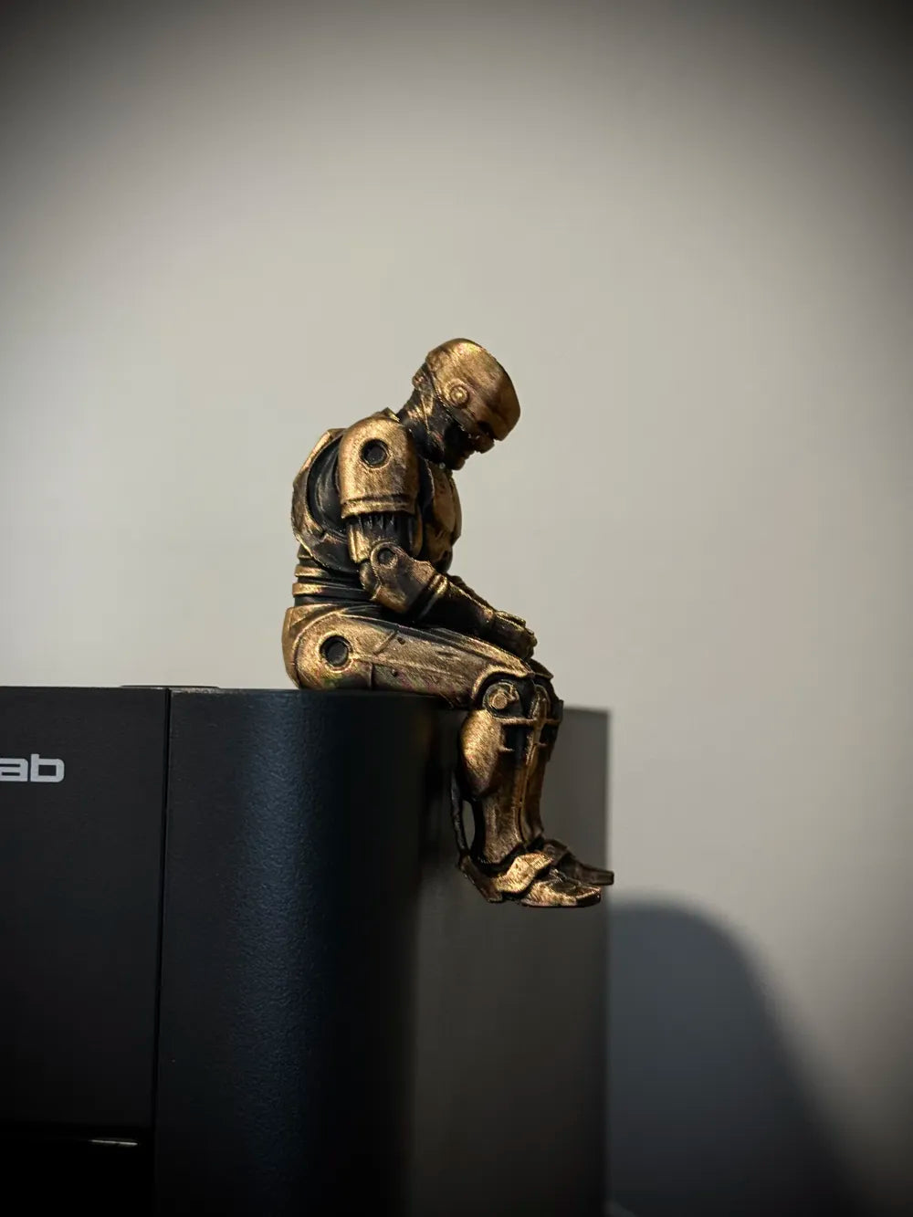 Sad RoboCop figurine sitting on a ledge!