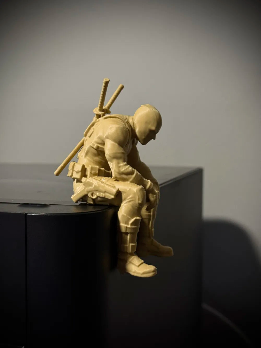 Sad Deadpool sitting on a ledge Figurine!