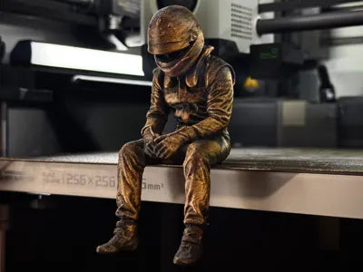 Sad F1 Driver Sitting on a ledge Figurine!