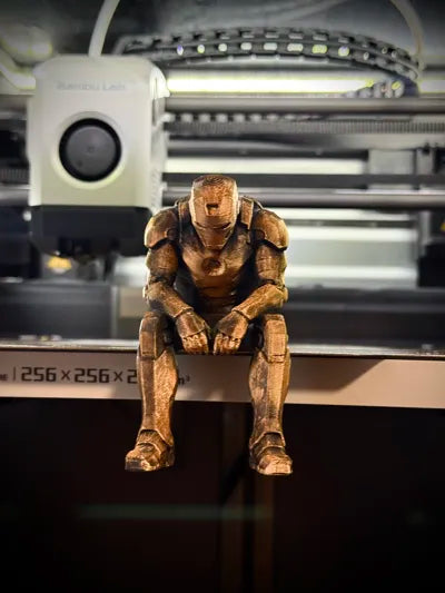 Sad Iron Man Figurine sitting on a ledge!