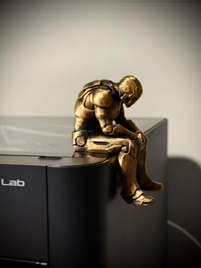 Sad Iron Man Figurine sitting on a ledge!