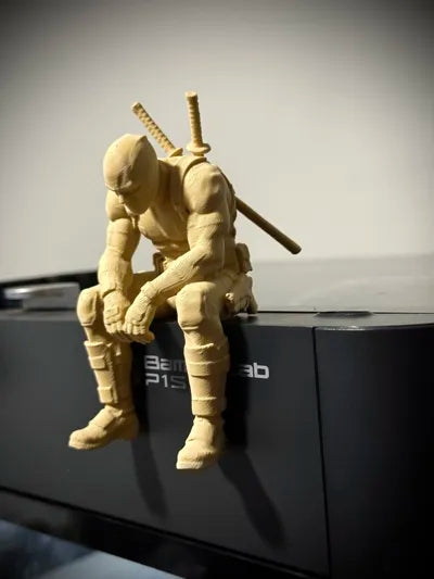 Sad Deadpool sitting on a ledge Figurine!