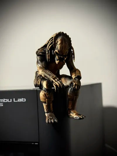 Sad Predator Figurine sitting on a ledge!